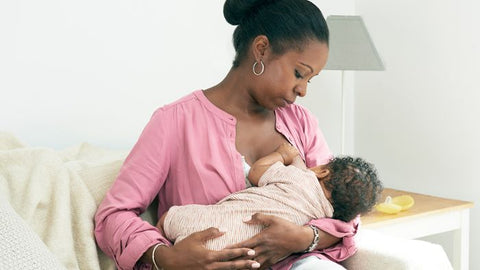 Mother breastfeeding baby in cradle hold