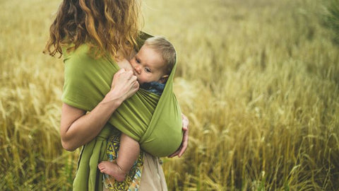 Mother breastfeeding baby in a sling