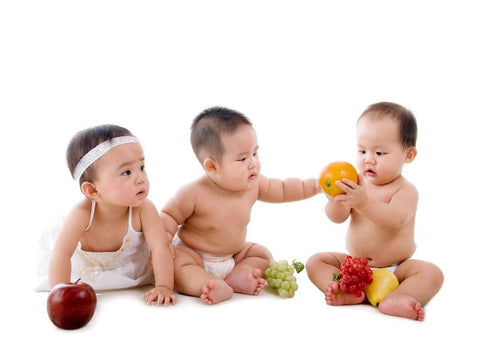 Three babies playing with fruit as part of nutrition in pregnancy blog on Be Active Maternity website.