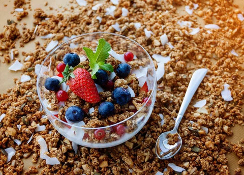 Homemade granola or muesli with berries as part of nutrition in pregnancy blog on Be Active Maternity and nursing activewear website.