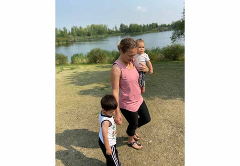 Woman wearing maternity and nursing tank and walking with kids