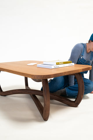 Hardwood coffee table with a unique "X" base of two mirrored leg frame components (solid walnut) and a solid white oak tabletop