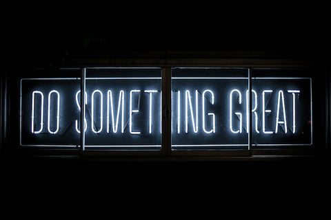 A "do something great" neon sign.