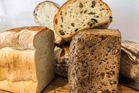 Various different bread products positioned on a table