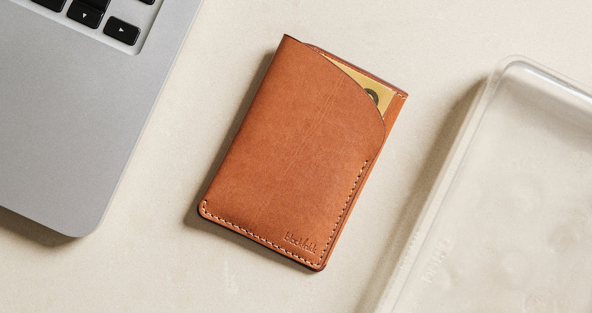 Flatlay image of Two Pocket Cardholder with laptop and water bottle