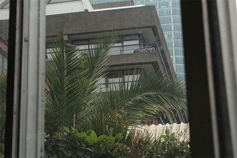 View of the barbican estate through the window of the barbican conservatory 