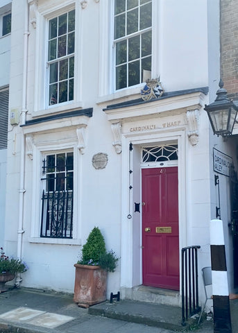 The exterior of Cardinal's Wharf has a bright red front door