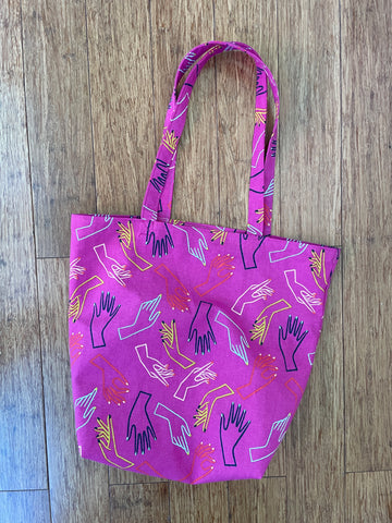 pink canvas hand made bag with drawings of hands