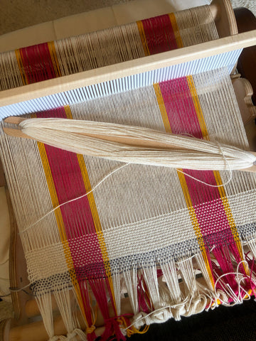 small rigid heddle loom from above, warped in a striped pattern