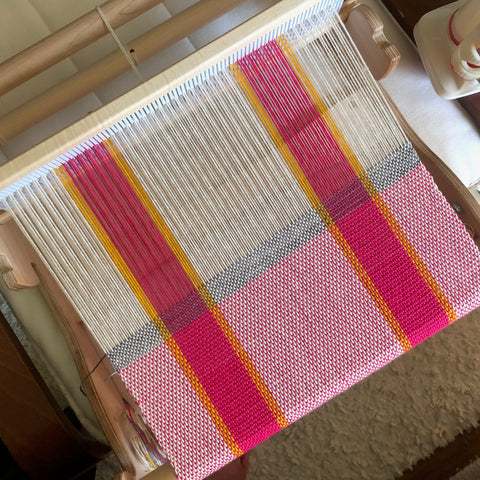 a rigid heddle from above, warped with a three-color cotton warp kitchen towel project