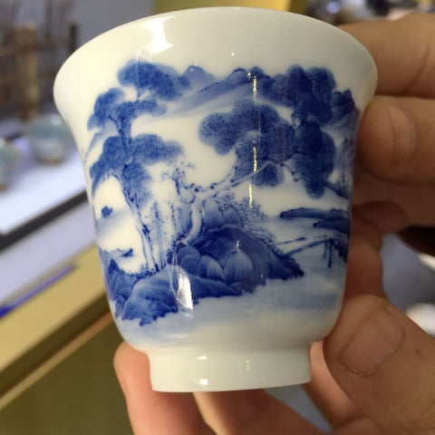 Handmade Porcelain Cup with Qinghua (blue) painted motif.