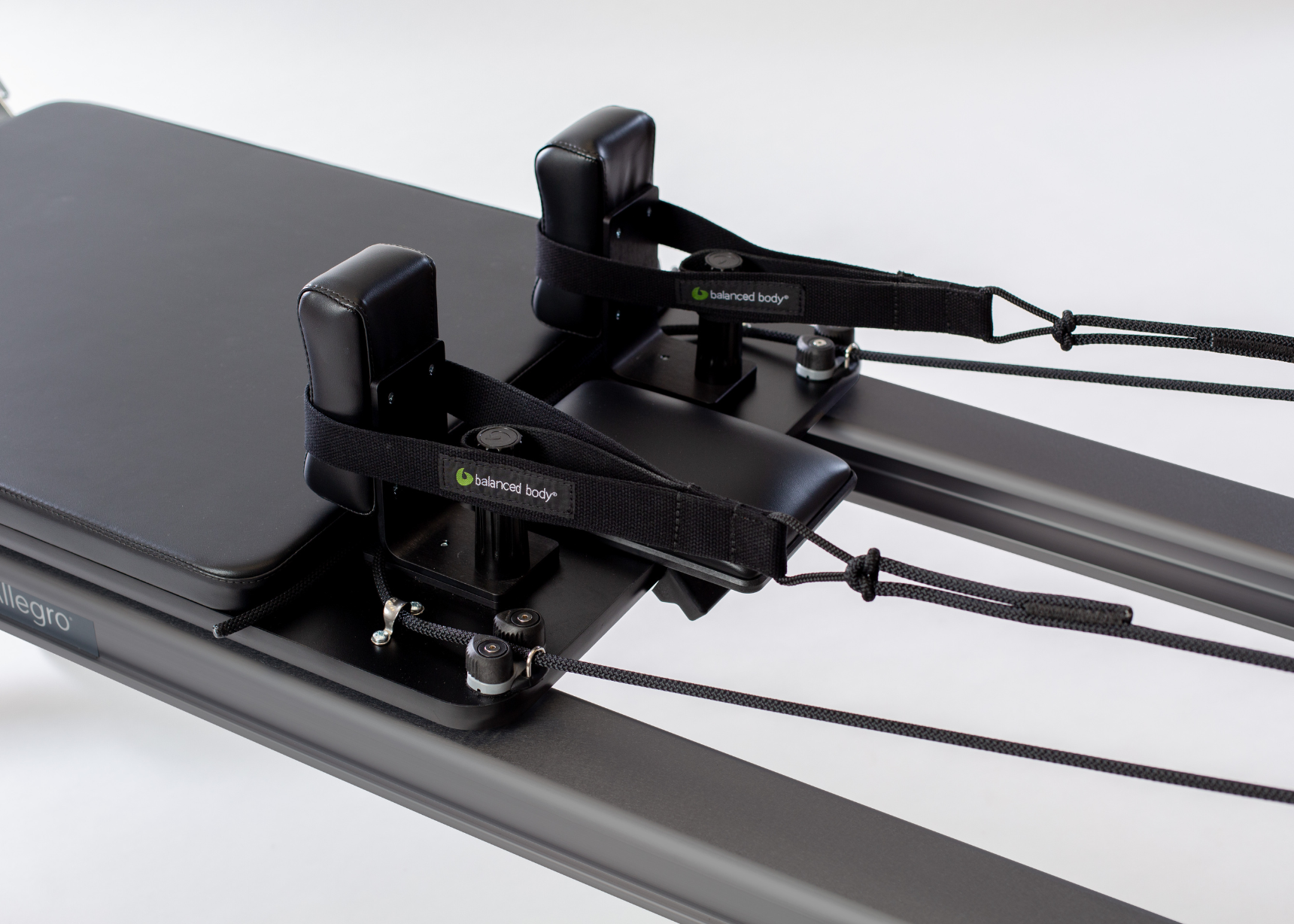 Allegro Reformer with Tower and Mat, with focus on Balanced Body handles.
