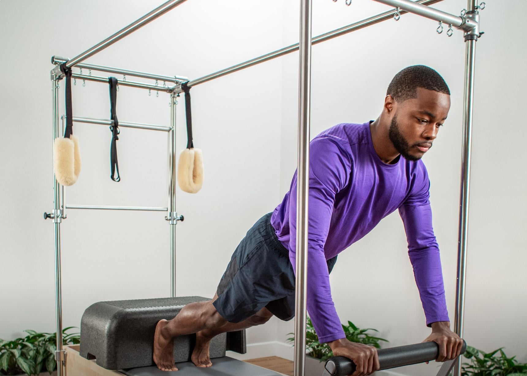 Man using the reformer trapeze combination 