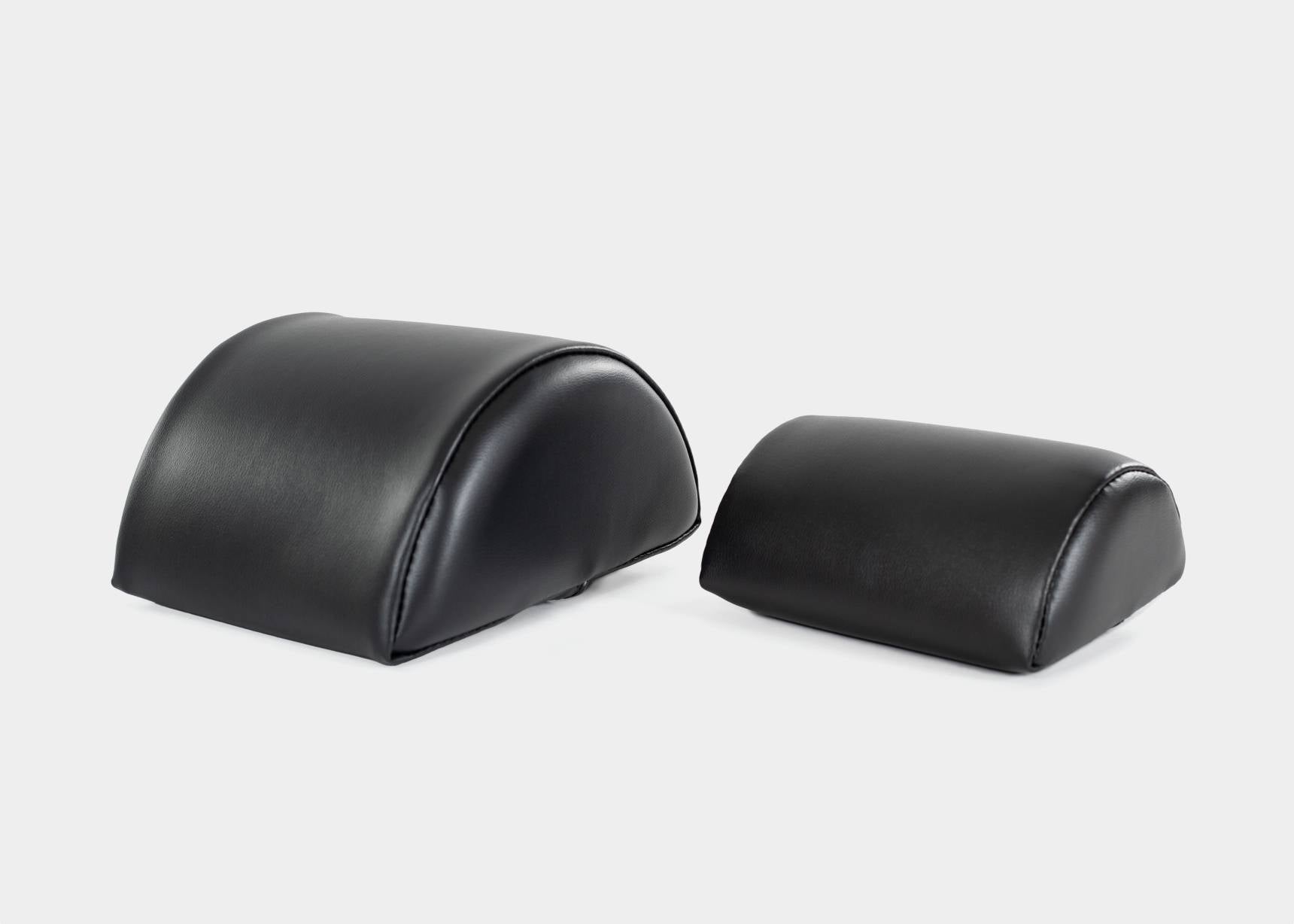 Black half-cylinder cushions for support and alignment.