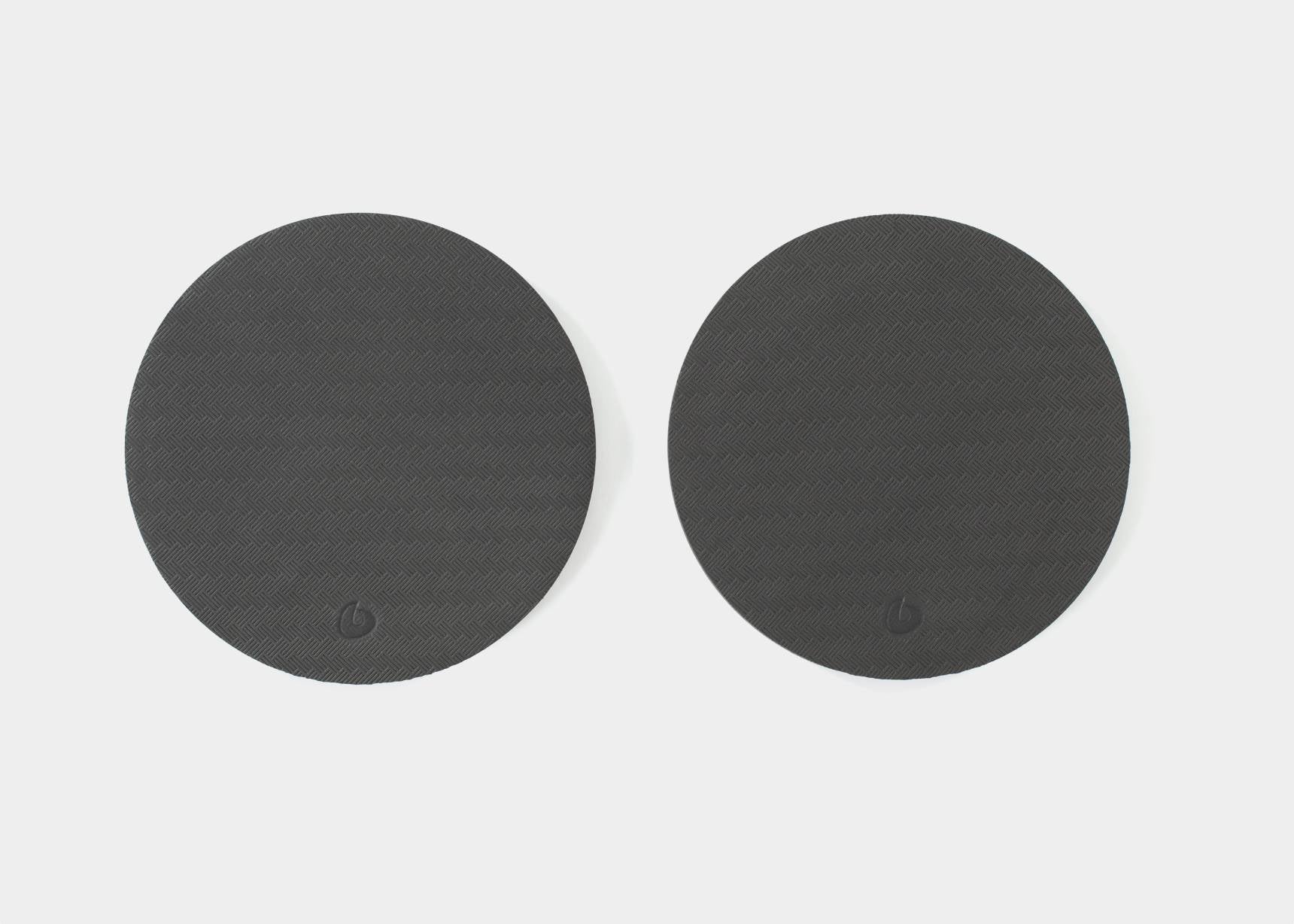 Two black Balanced Body rotator disc pads.