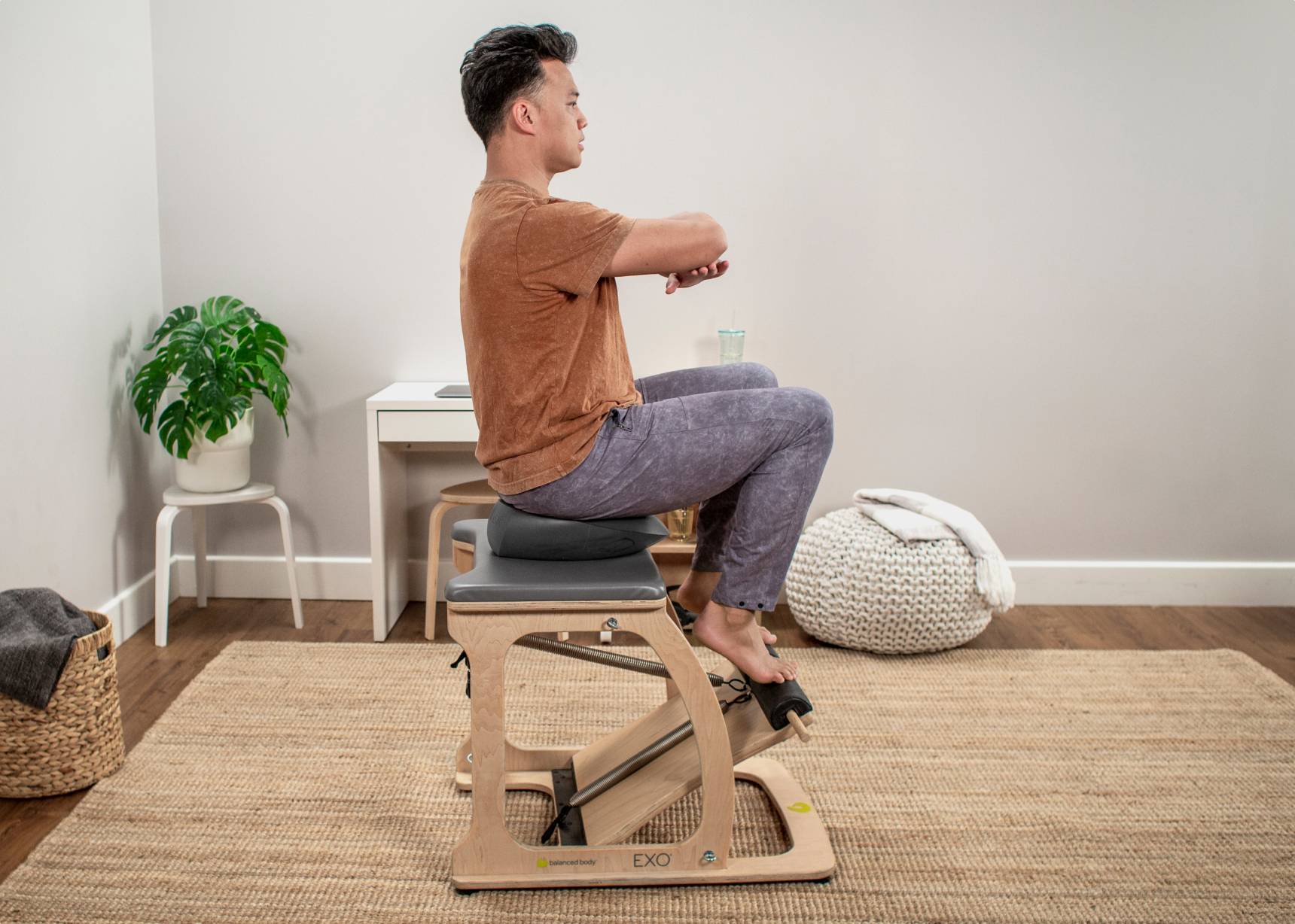 Man engaging in a dynamic workout routine using a Balansit cushion.