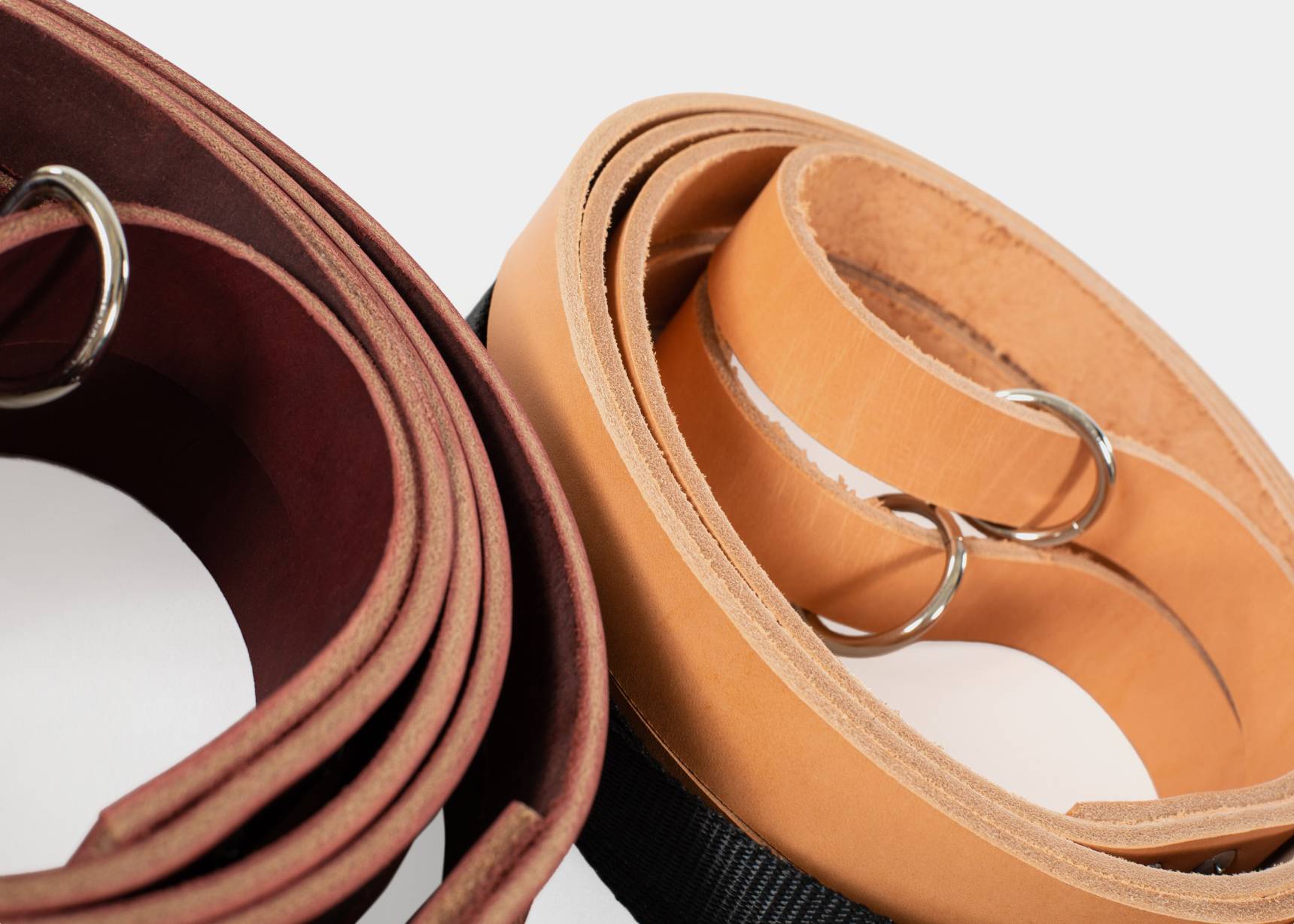 Detailed view of leather reformer straps, showcasing both oak tanned and latigo variants.