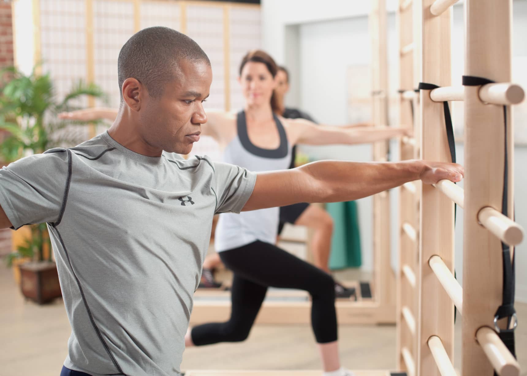 Portrait of Woman Pilates Trainer Doing Exersices on the Ladder