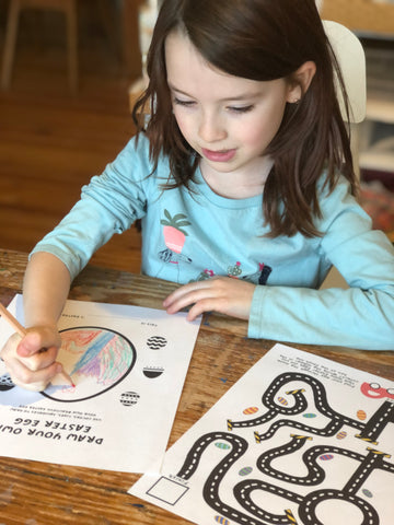 girl drawing an Easter egg