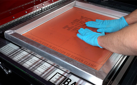 hands smoothing film on a screen
