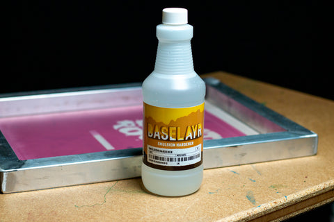 a bottle of emulsion hardener next to a coated screen