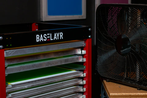 box fan next to a screen rack