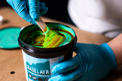 person mixing diazo into teal emulsion