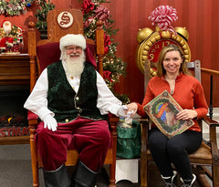 Santa Claus and Dorene Lorenz enjoy reading The Night Before Christmas