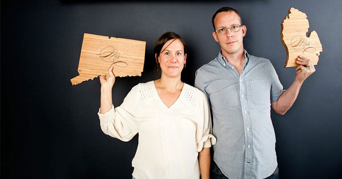 Amy and Bill display their custom-made state shaped cutting boards