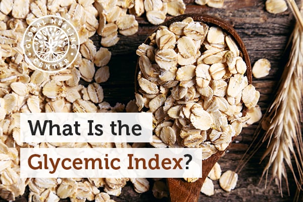 A wooden spoon full of oats. Foods like hummus, carrots, quinoa, and oats are ranked low in the glycemic index food chart.