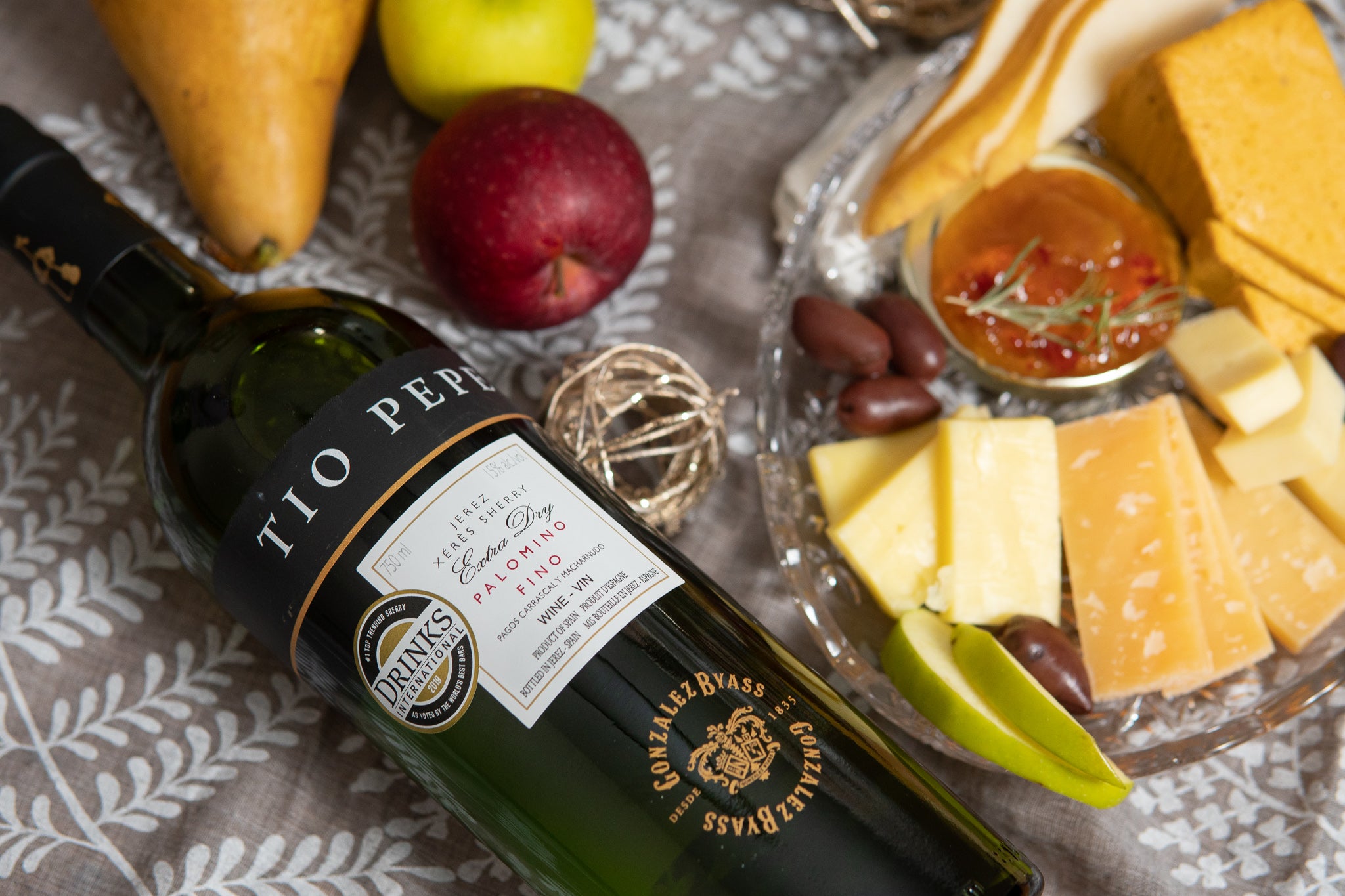 Tio Pepe sherry wine bottle with fresh fruit and a cheese platter