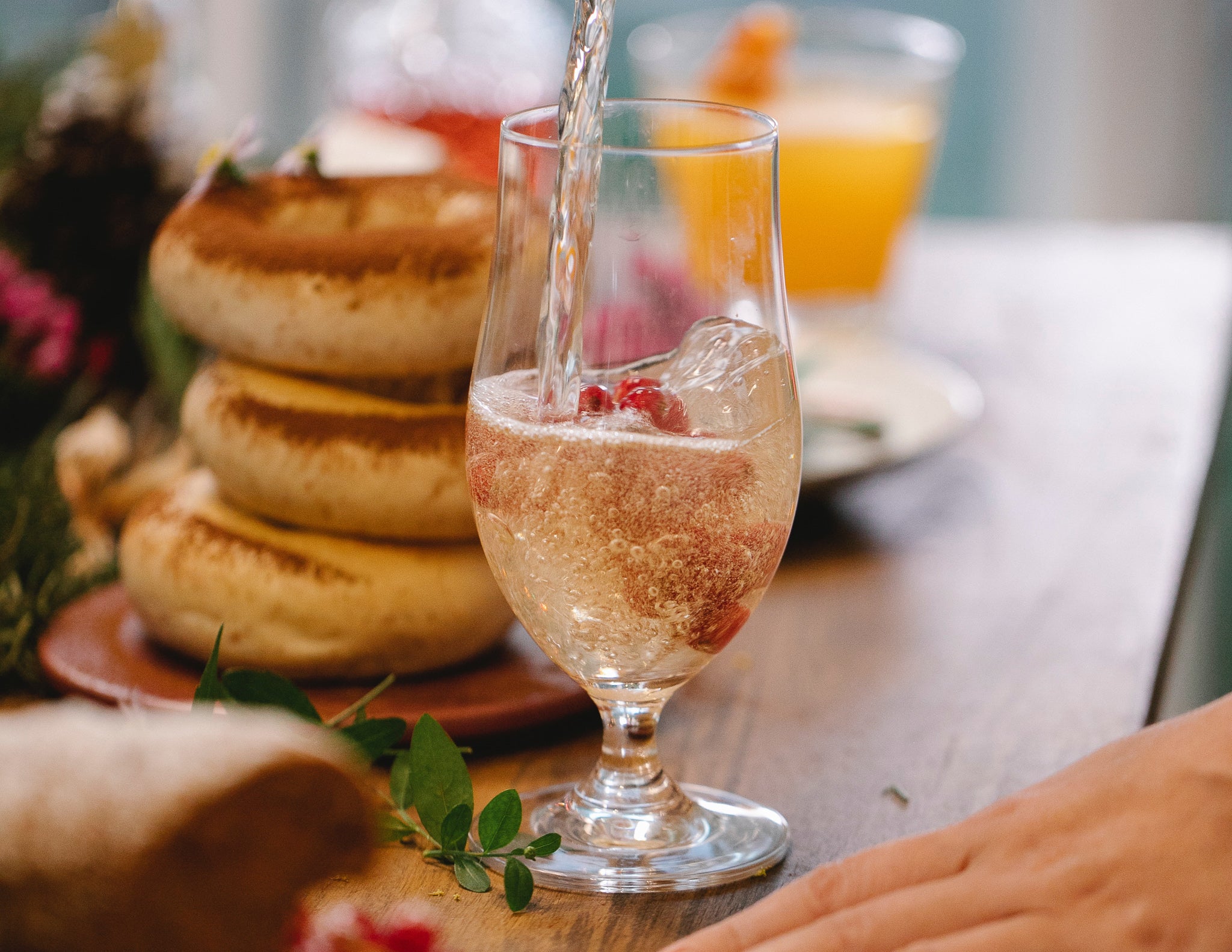 Champagne and sparkling wine cocktails made at home with food on a table