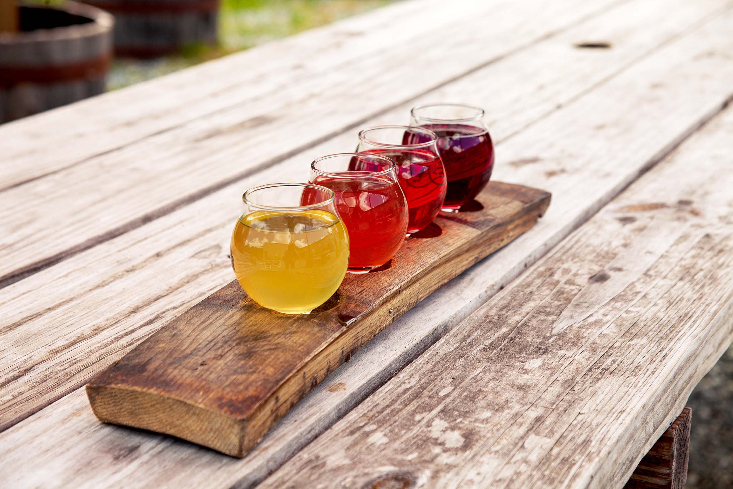 Cider flight of 5 different types on a wood table