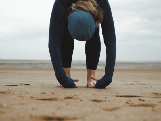 Rebecca Cartlidge practicing yoga on the beach