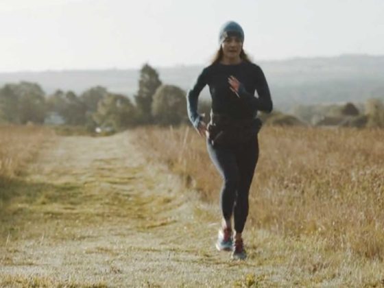 Rebecca Cartlidge running across a mown field