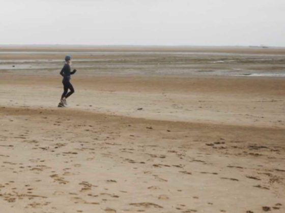 Rebecca Cartlidge running on the beach
