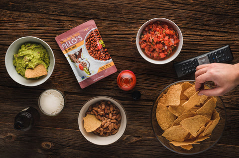 Game time spread of chips and dips, including FILLO'S Tex-Mex Pintos