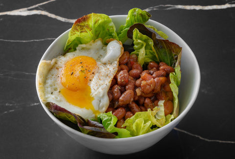Salad with sofrito beans and fried egg