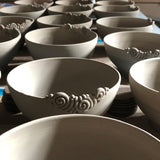 Production line of numerous handmade custom Buddha bowls drying