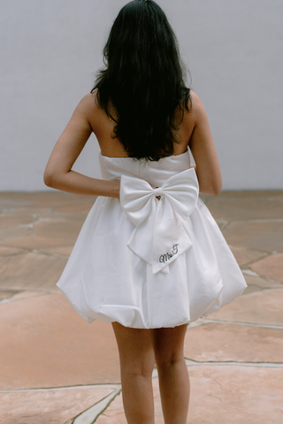 short personalized bow against bride's bridal shower dress