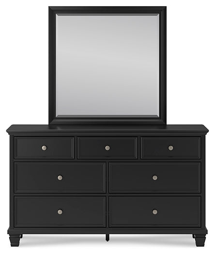 Lanolee King-Size Panel Bed Accompanied by a Mirrored Dresser and Chest