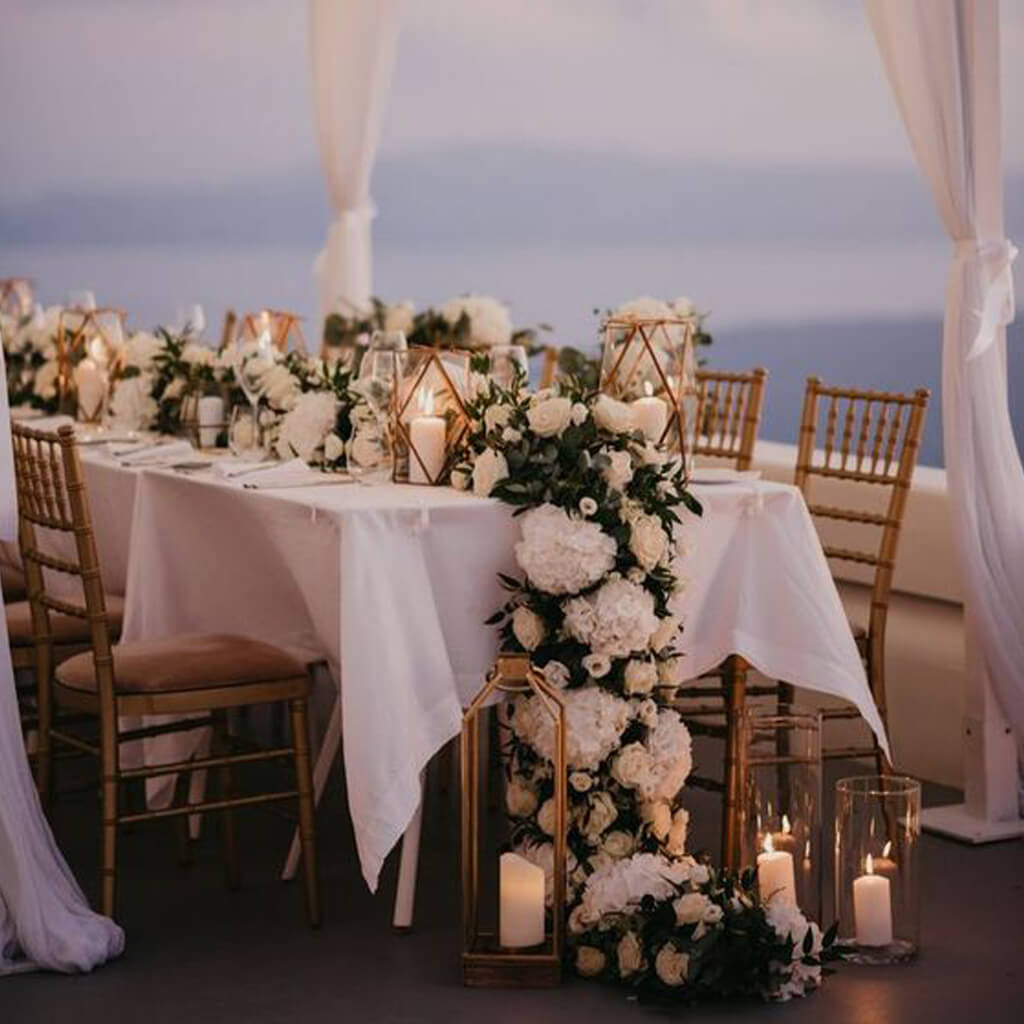 A wedding dinner table filled with flowers and candles