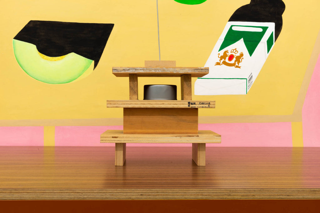 Miduny, MiMi table, Canaletto walnut, furniture grade birch plywood and orange paint; B. Wurtz, Untitled, wood, can, shell, wire; Crys Yin, Melon Soap Menthol Pack, Everything is Exactly the Same, Acrylic on Paper. Photo: Yael Eban.