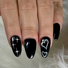 black and white gel polish airbrush design with hearts and stars