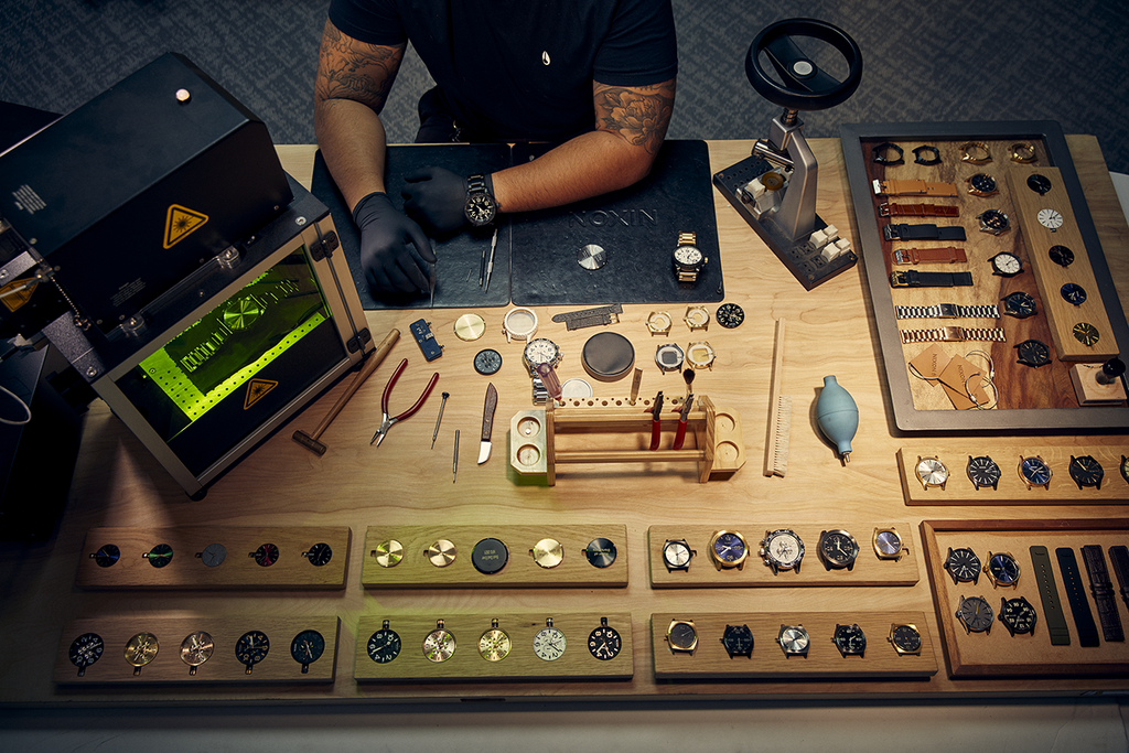 A selection of watch parts and a watch engraving machine at Nixon HQ