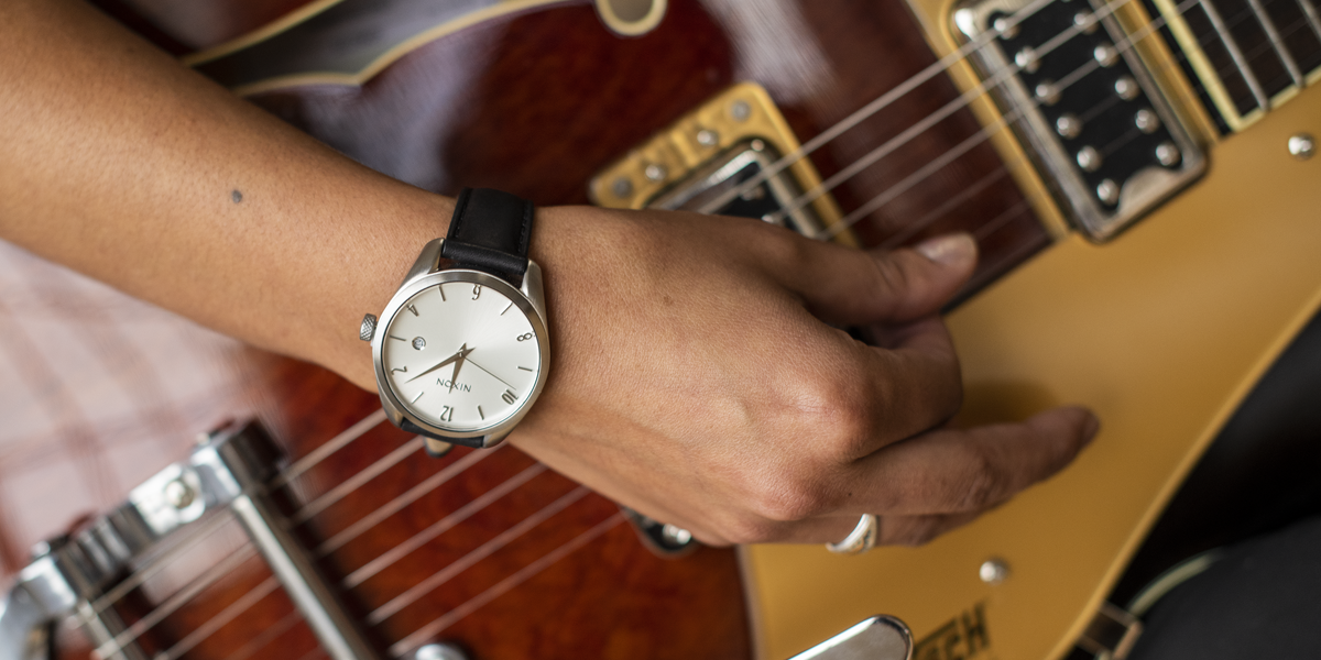 Woman playing guitar wearing Nixon Thalia Leather Watch