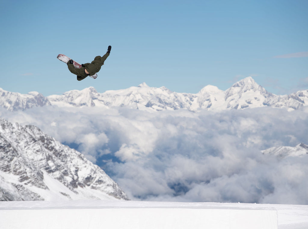 Nixon Team athlete Brock Crouch catches air while snowboarding.