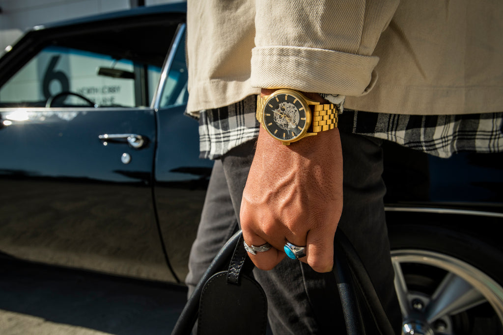 Man carries a bag wearing the Nixon Spectra Automatic watch.