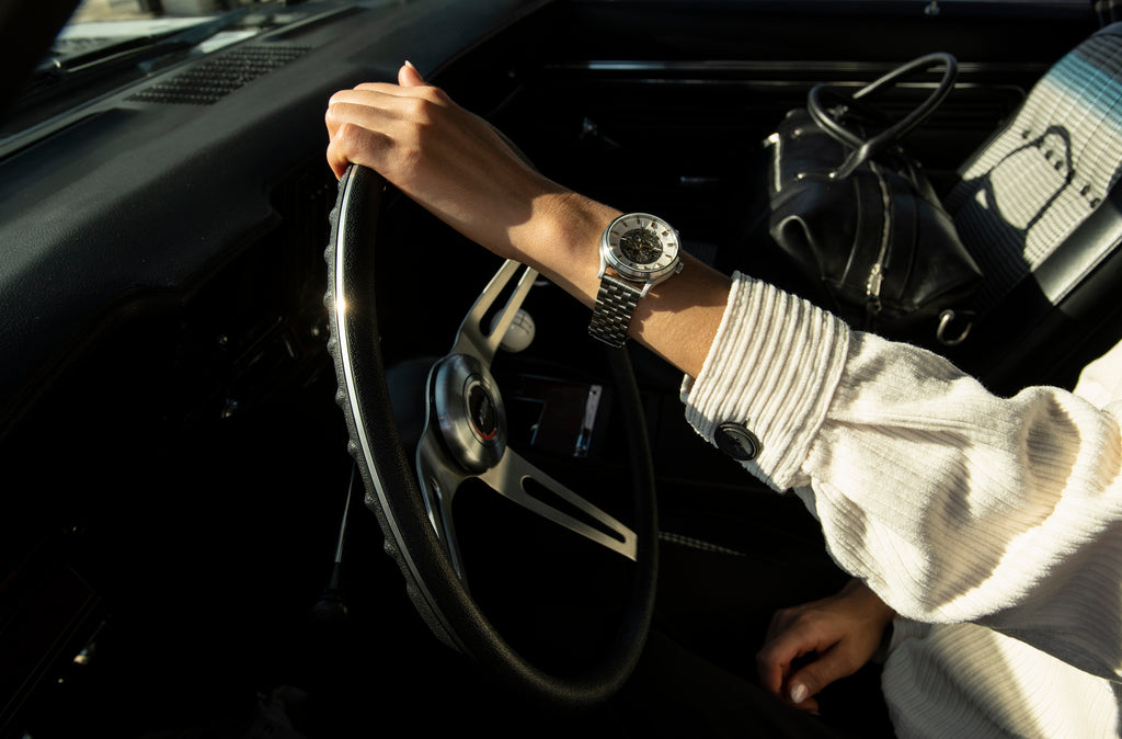 Silver and white Spectra Automatic watch on a female car driver