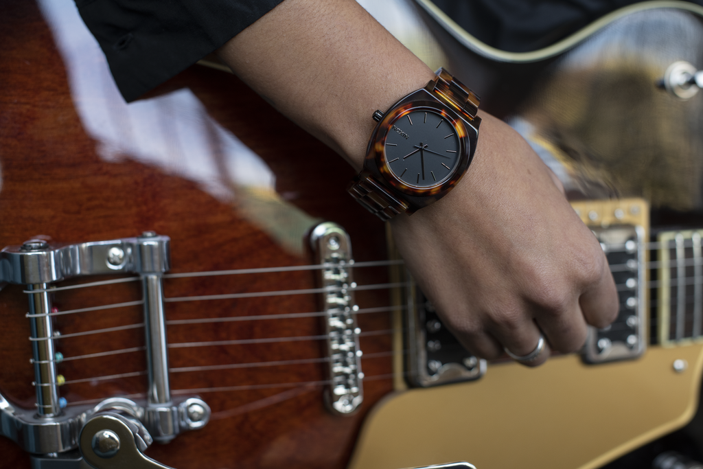 Guitarist wearing the Nixon Time Teller Acetate with Quartz movement